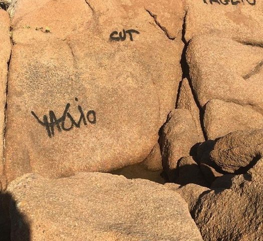 Cafoni scatenati a Porto Istana: scritte con lo spray sulle rocce granitiche della spiaggia