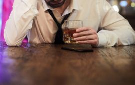 Depressed Man Drinking in Bar