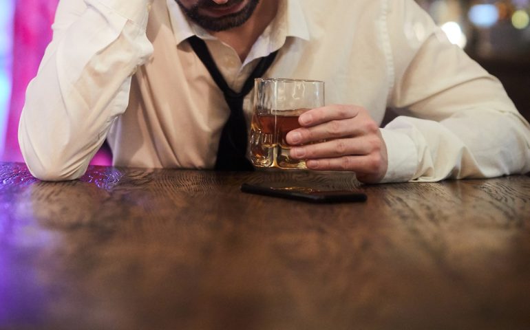 Depressed Man Drinking in Bar