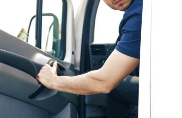 Man backing out delivery van