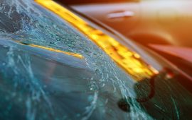 Broken glass on a car with broken windshield after crash accident