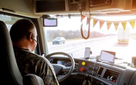 Driver in cabin of big modern truck