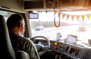 Driver in cabin of big modern truck