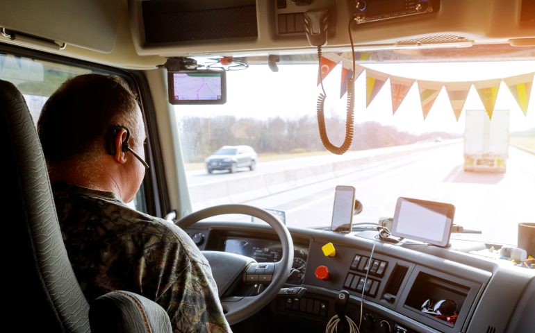 Driver in cabin of big modern truck